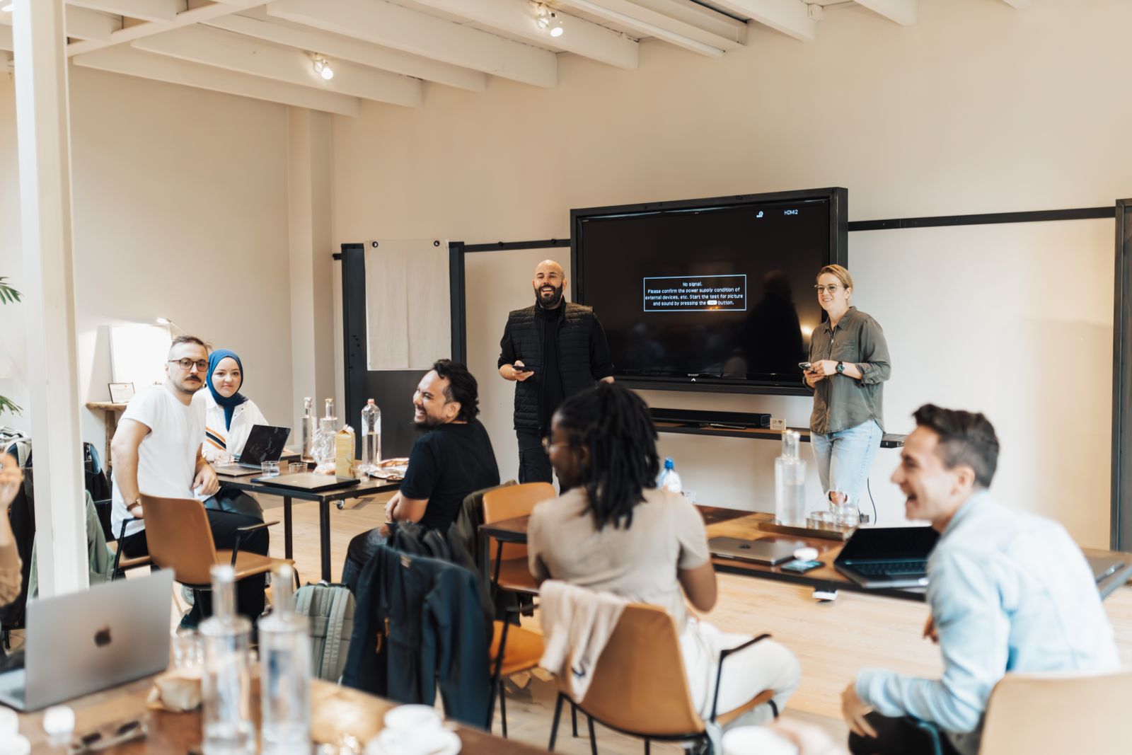 A team gathered around a table for an office presentation