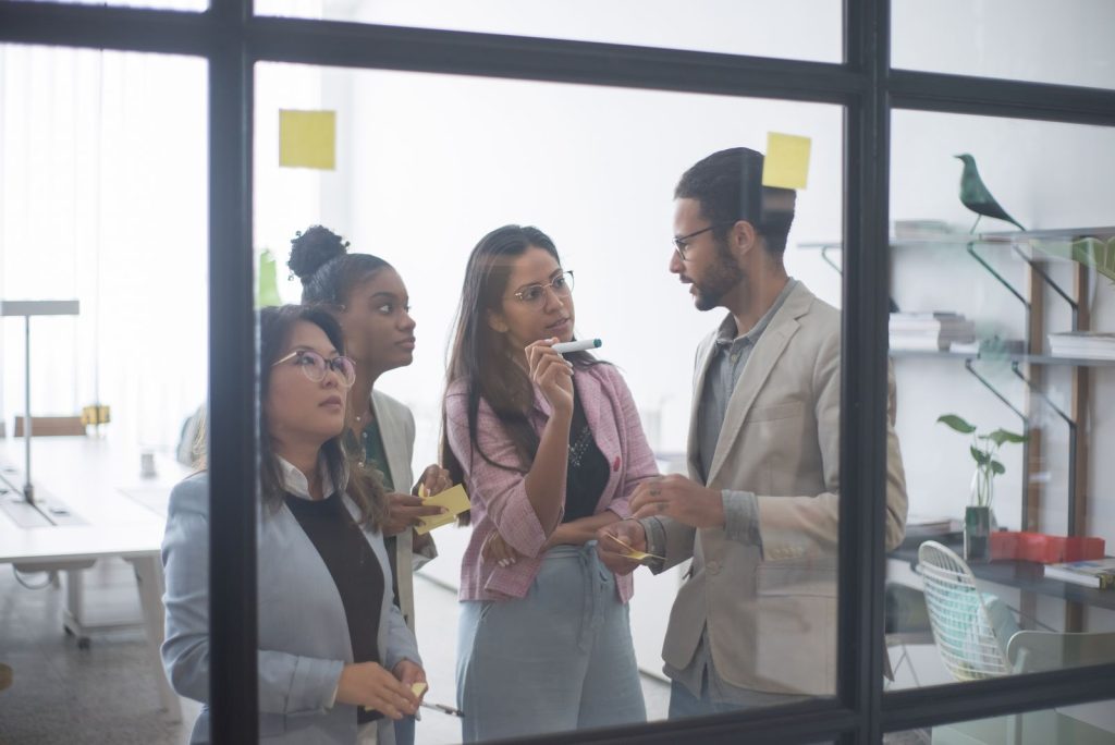 Colleagues discussing work in a bright office