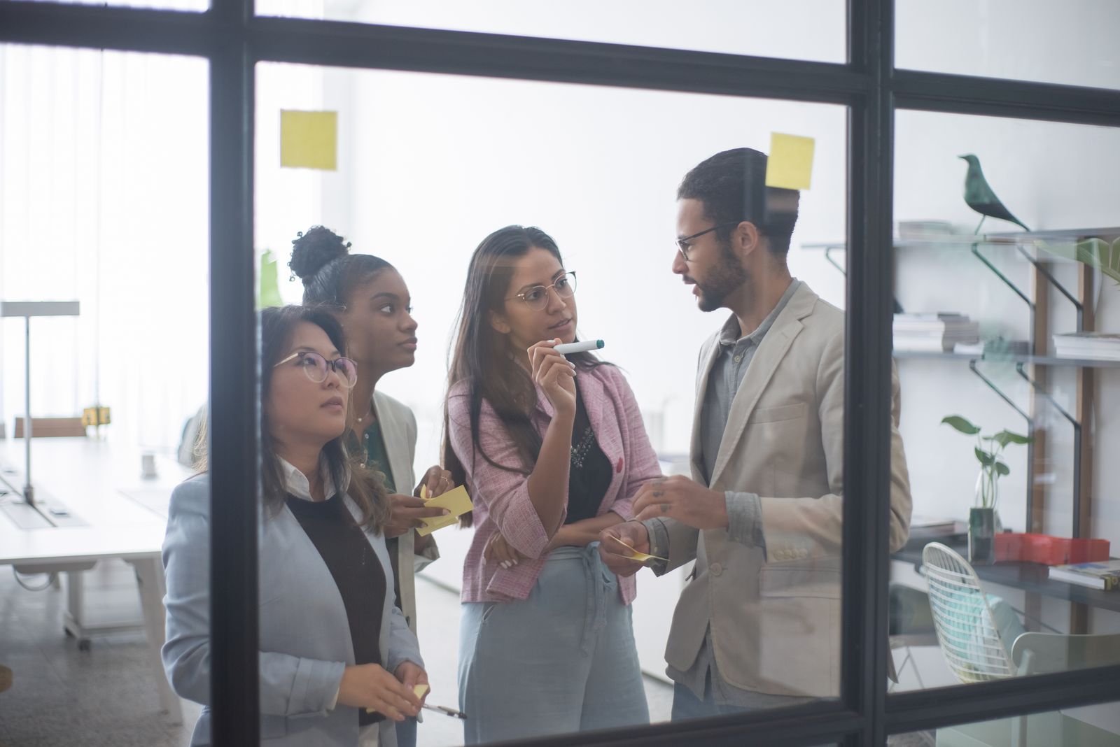 Colleagues discussing work in a bright office
